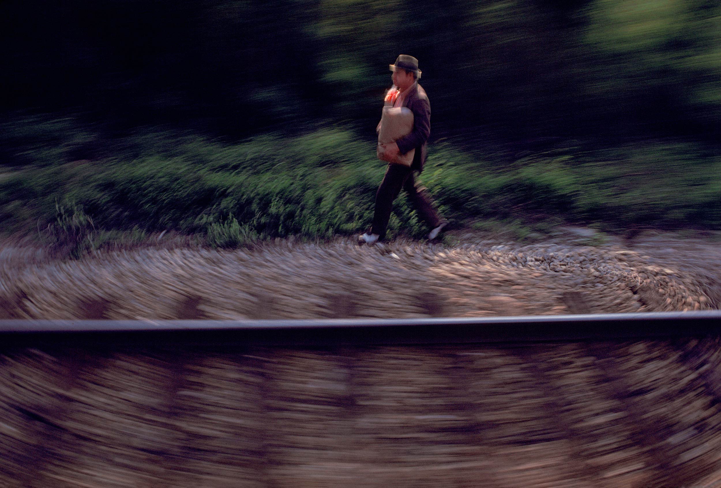 Man-walking-w-groceries.RR-tracks-Mtta-web